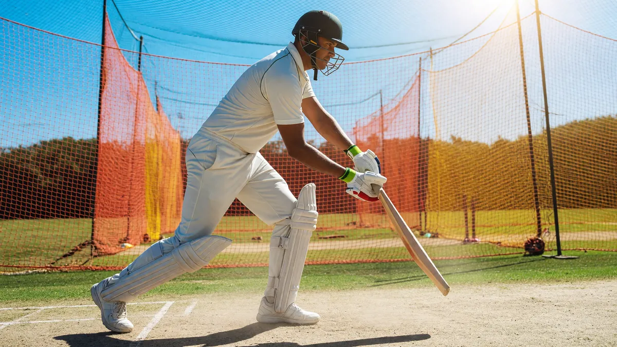 Editorial photograph of a cricket batsman in stance at the crease, daylight session